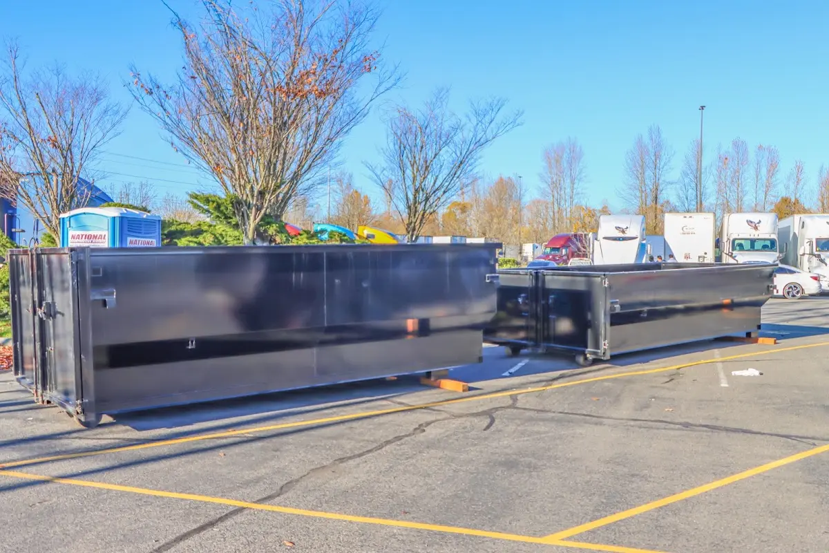 Professional dumpster rental service with roll-off container on residential driveway in Orem